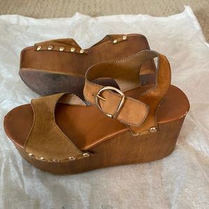 Used wood and leather studded platforms.